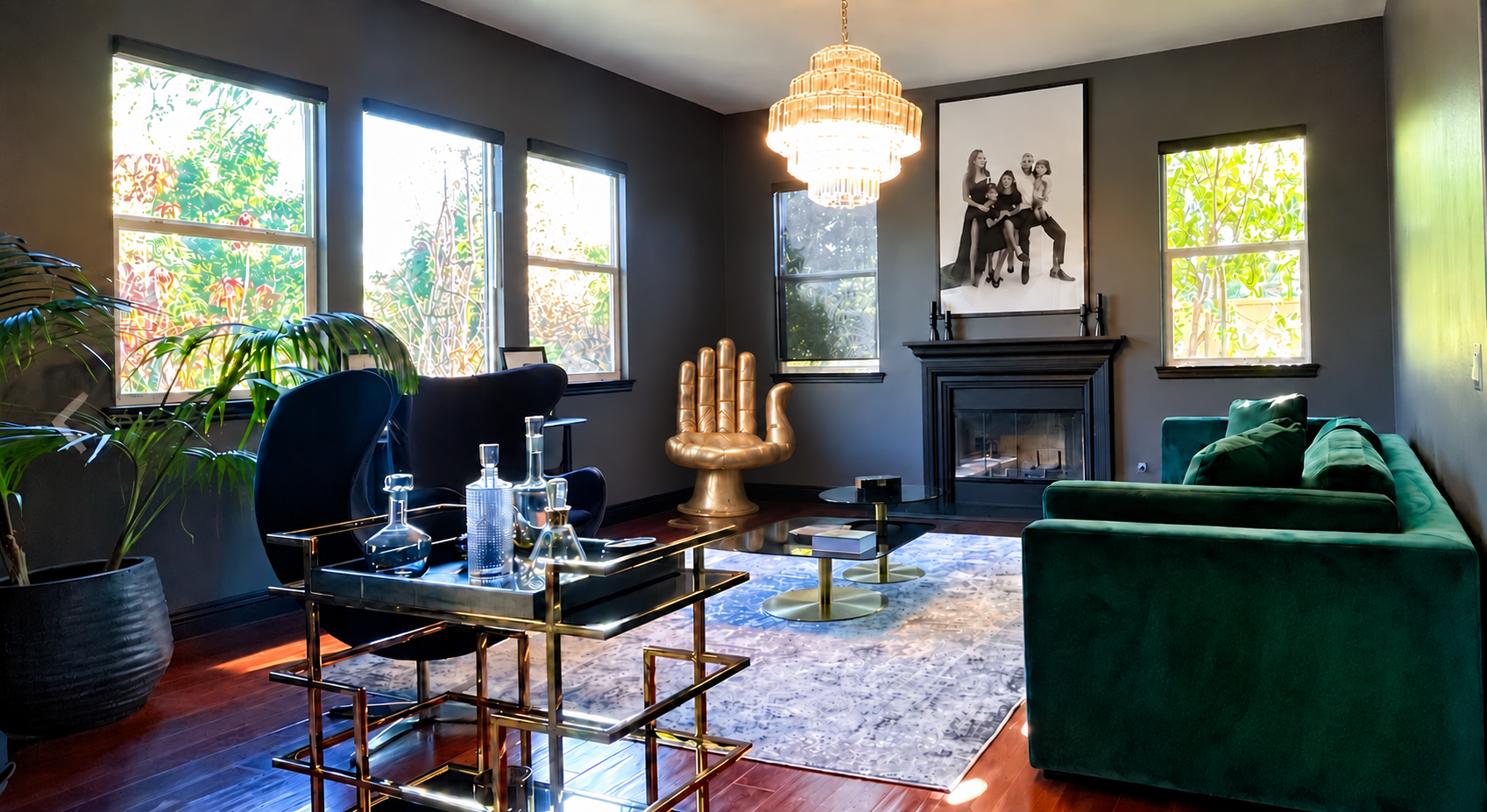 Emerald sofa and sculptural gold hand chair in a glamorous lounge
